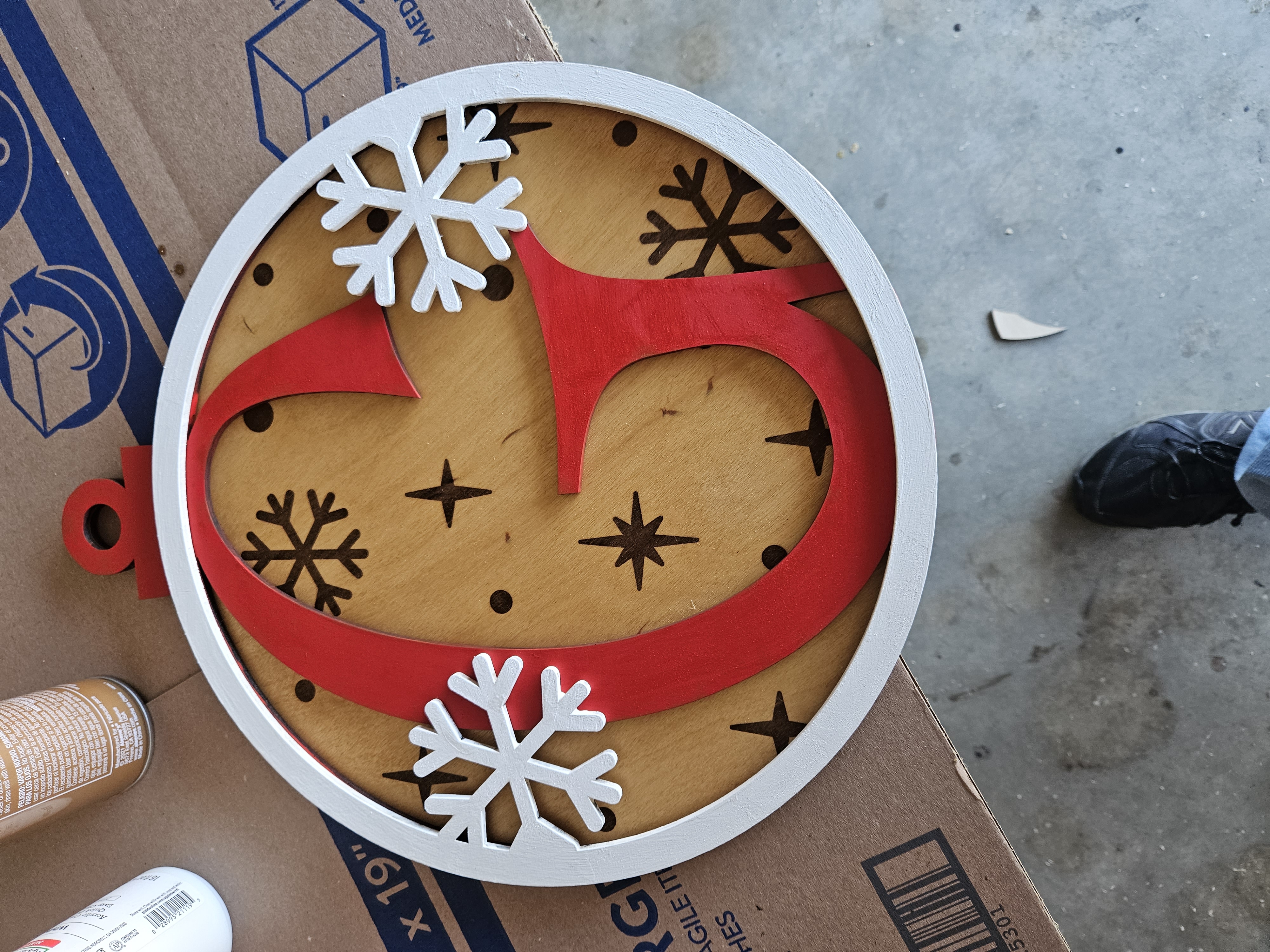 A snowflake-shaped door hanger engraved with a monogram