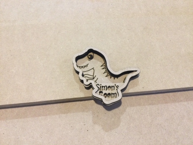 Layered wooden dinosaur name plate for a kids room door