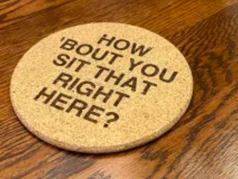 Funny Cork Trivet laser cut design on a table