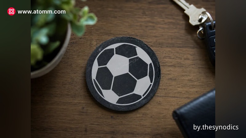 Round slate coaster with a soccer ball motif engraving