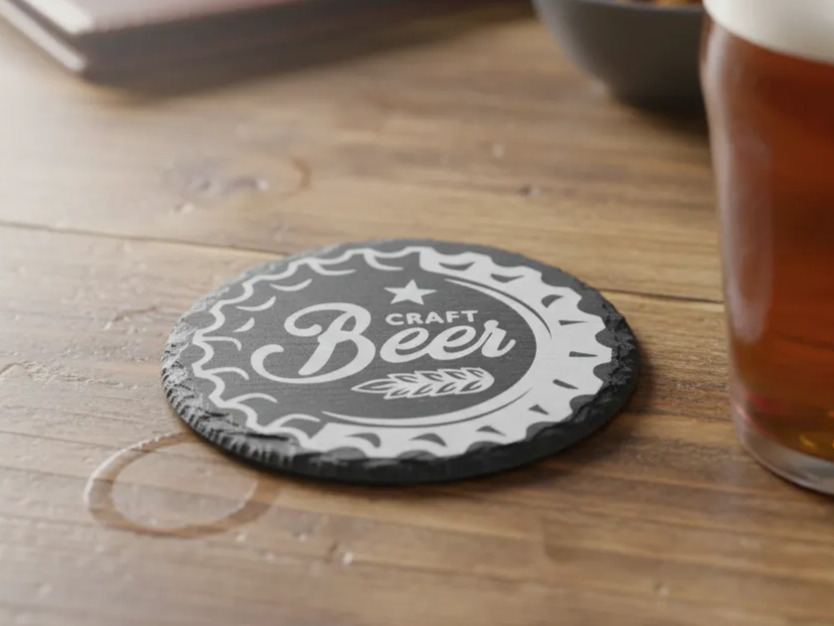 Slate coaster engraved with a craft beer bottle cap illustration