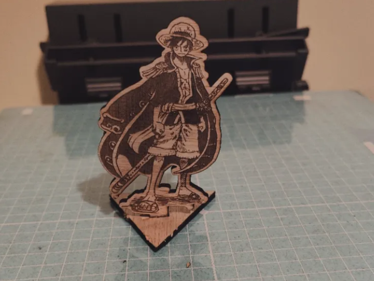 Wood engraved standing figure of Luffy holding sword on triangular base gift idea