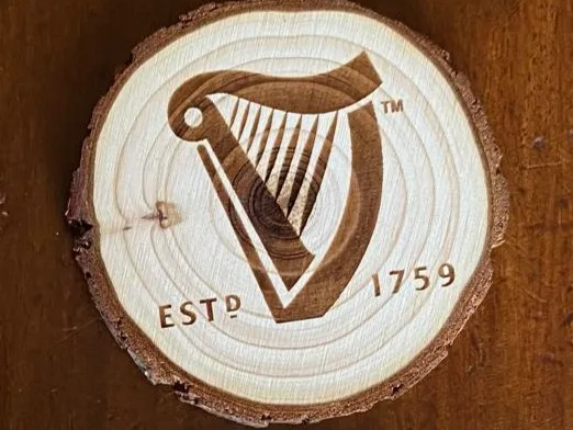 Coaster featuring a stout brand-style logo engraving