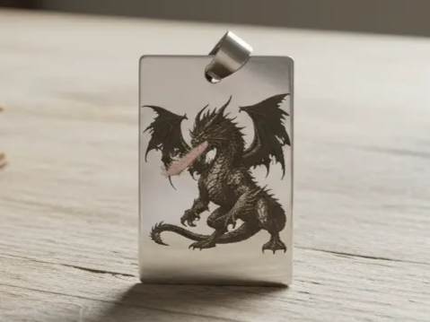 A polished metal pendant engraved with a fire-breathing dragon