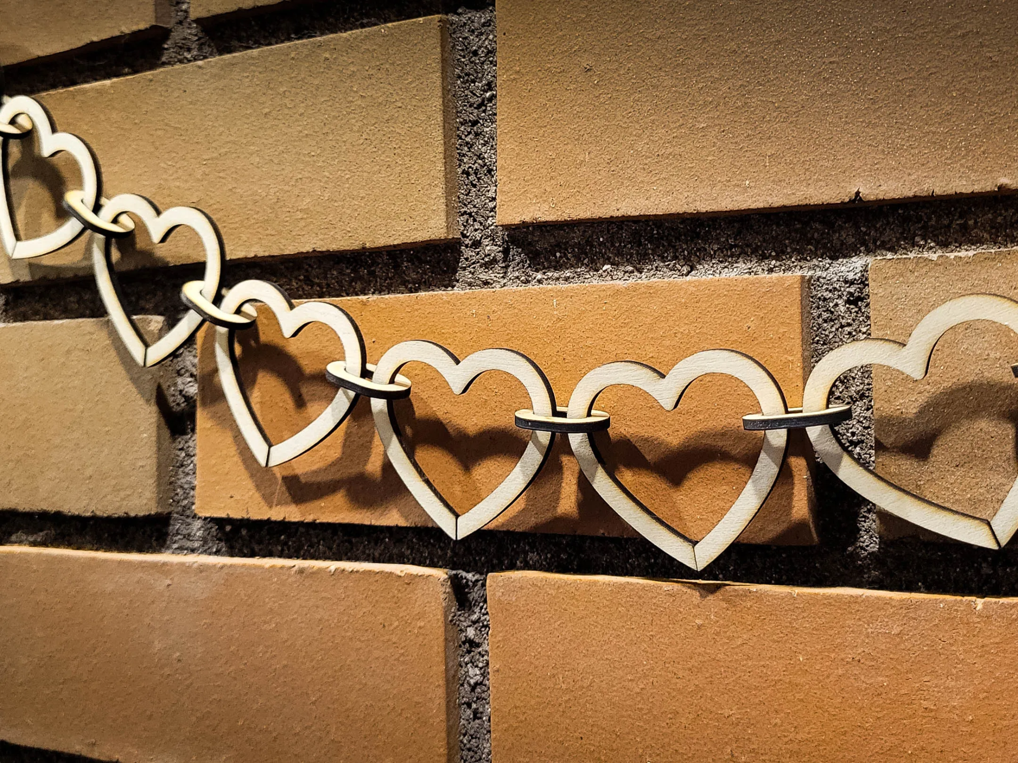 Laser cut wooden heart chain garland draped as tree decoration