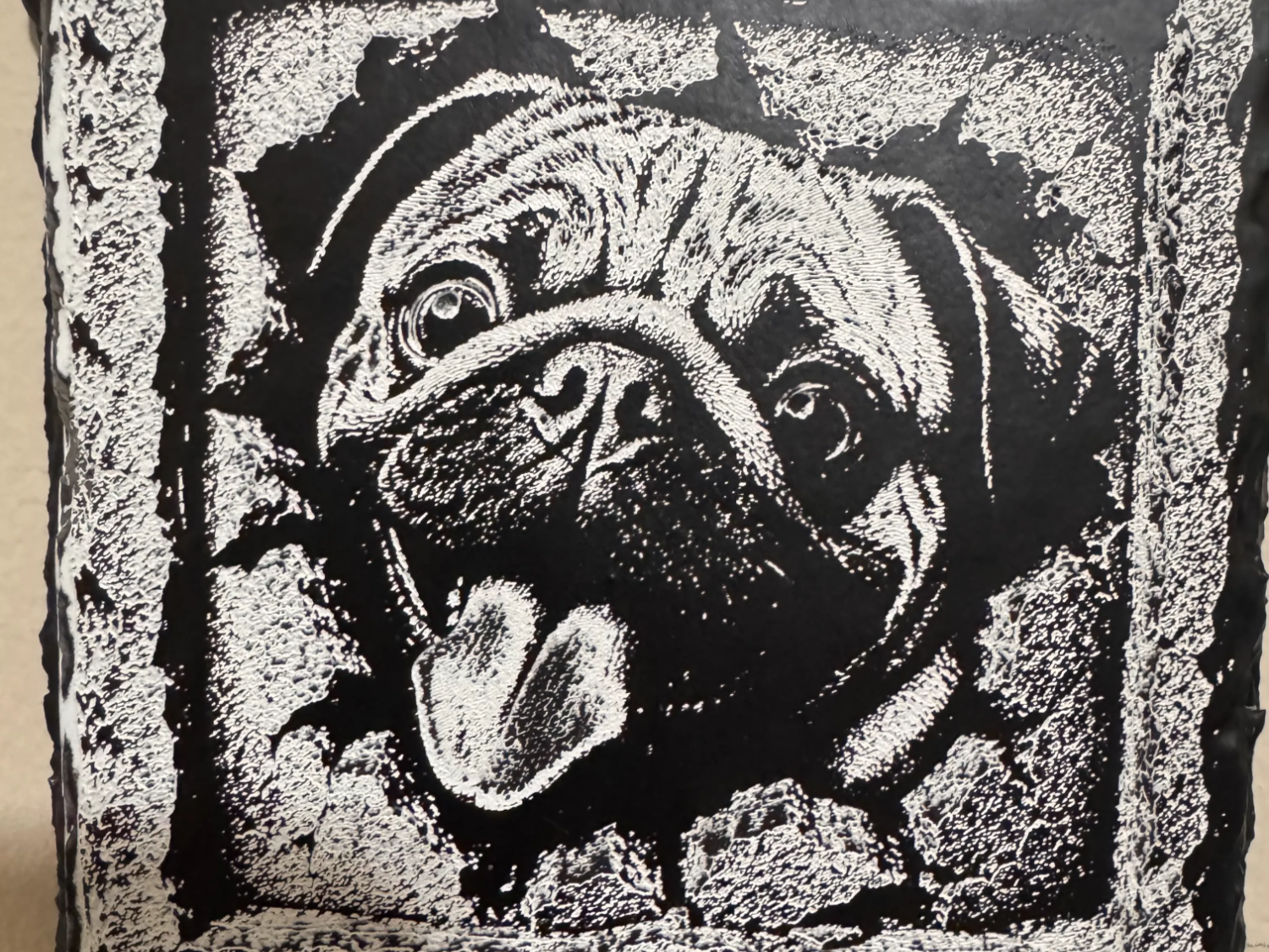 Black rock coaster engraved with a 3D optical illusion design