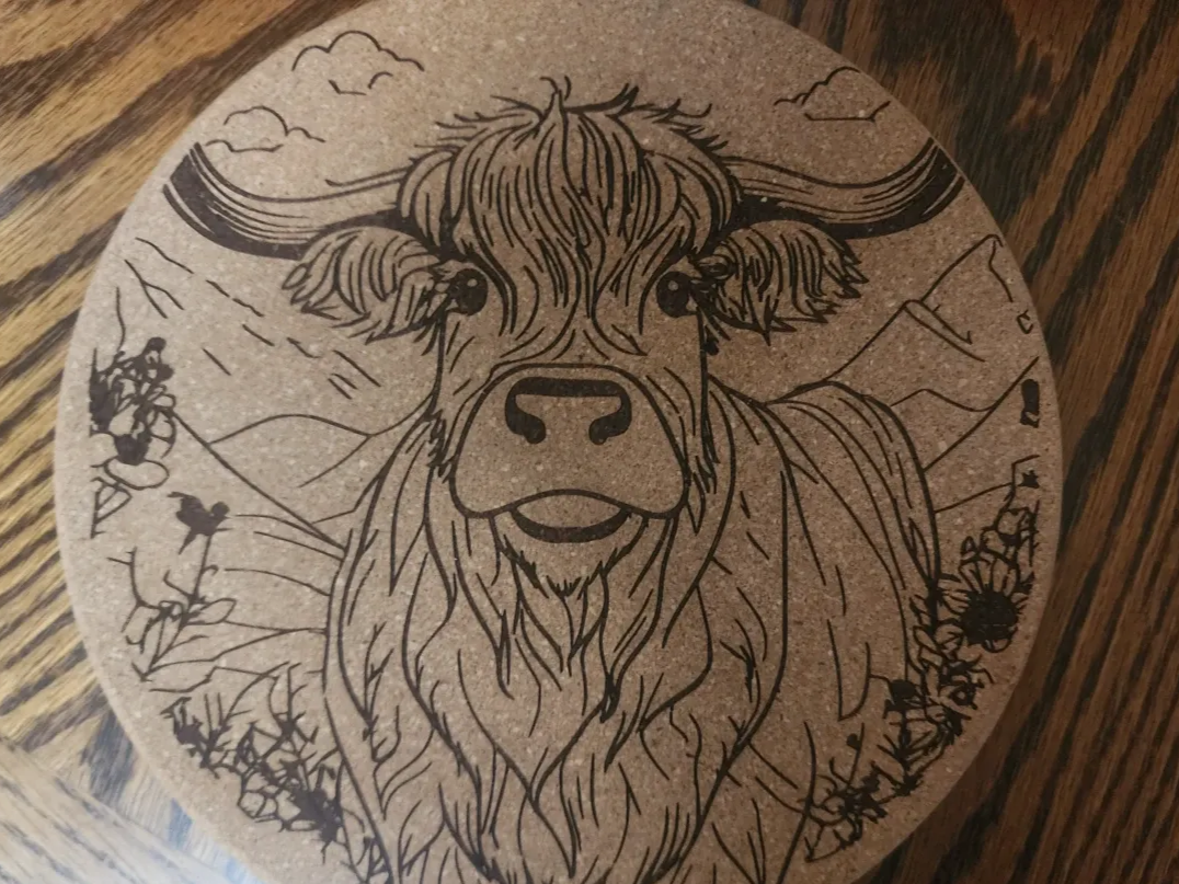 Highland Cow Trivet laser cut design on a table