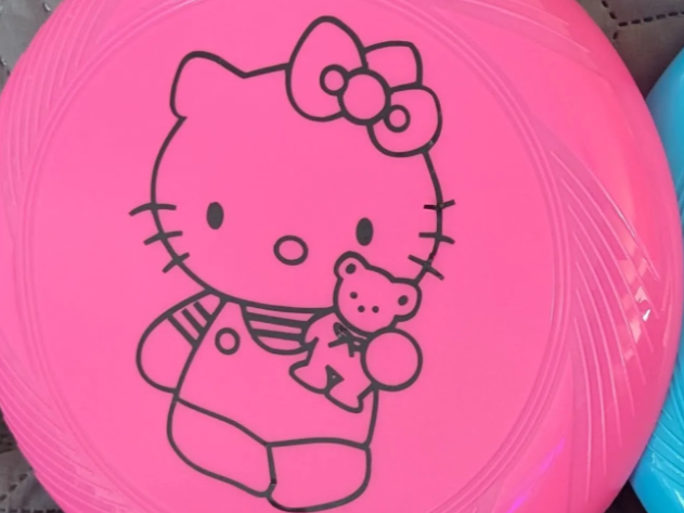 Pink plastic frisbee engraved with Hello Kitty holding a teddy bear gift idea