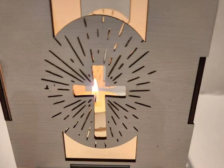 Wooden Holy Easter tealight holder with cross detail lit by a candle
