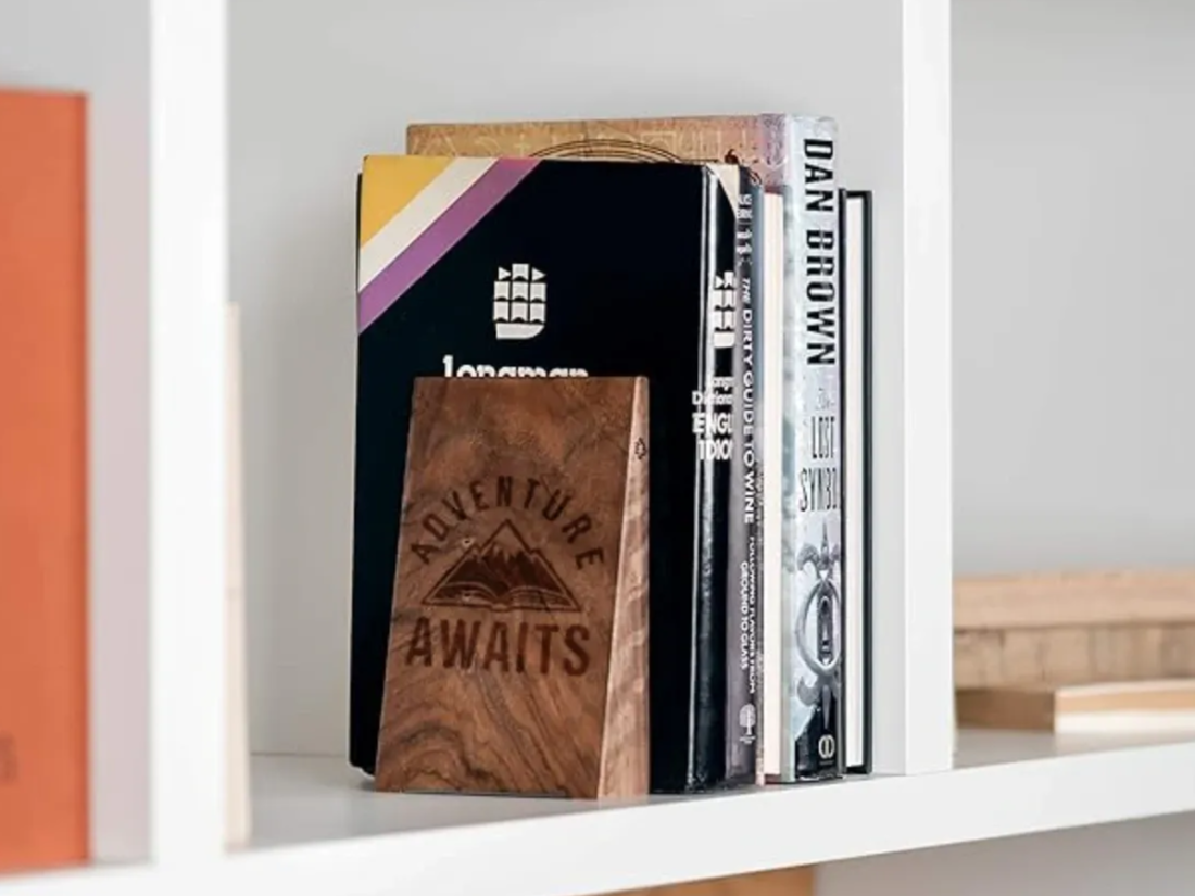 Adventure Waits Bookends laser-cut design on a styled shelf