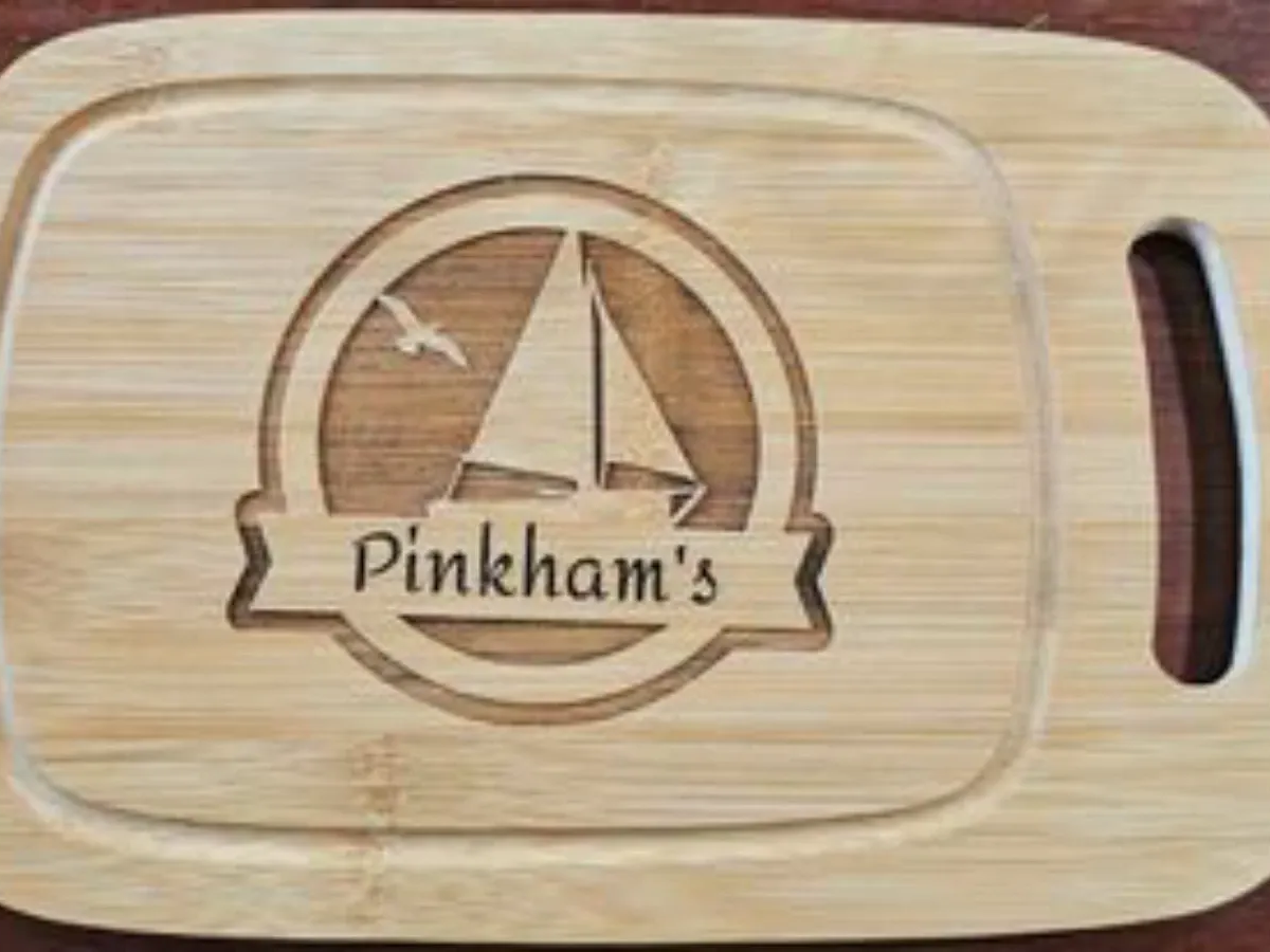 A charcuterie serving board engraved with a monogram