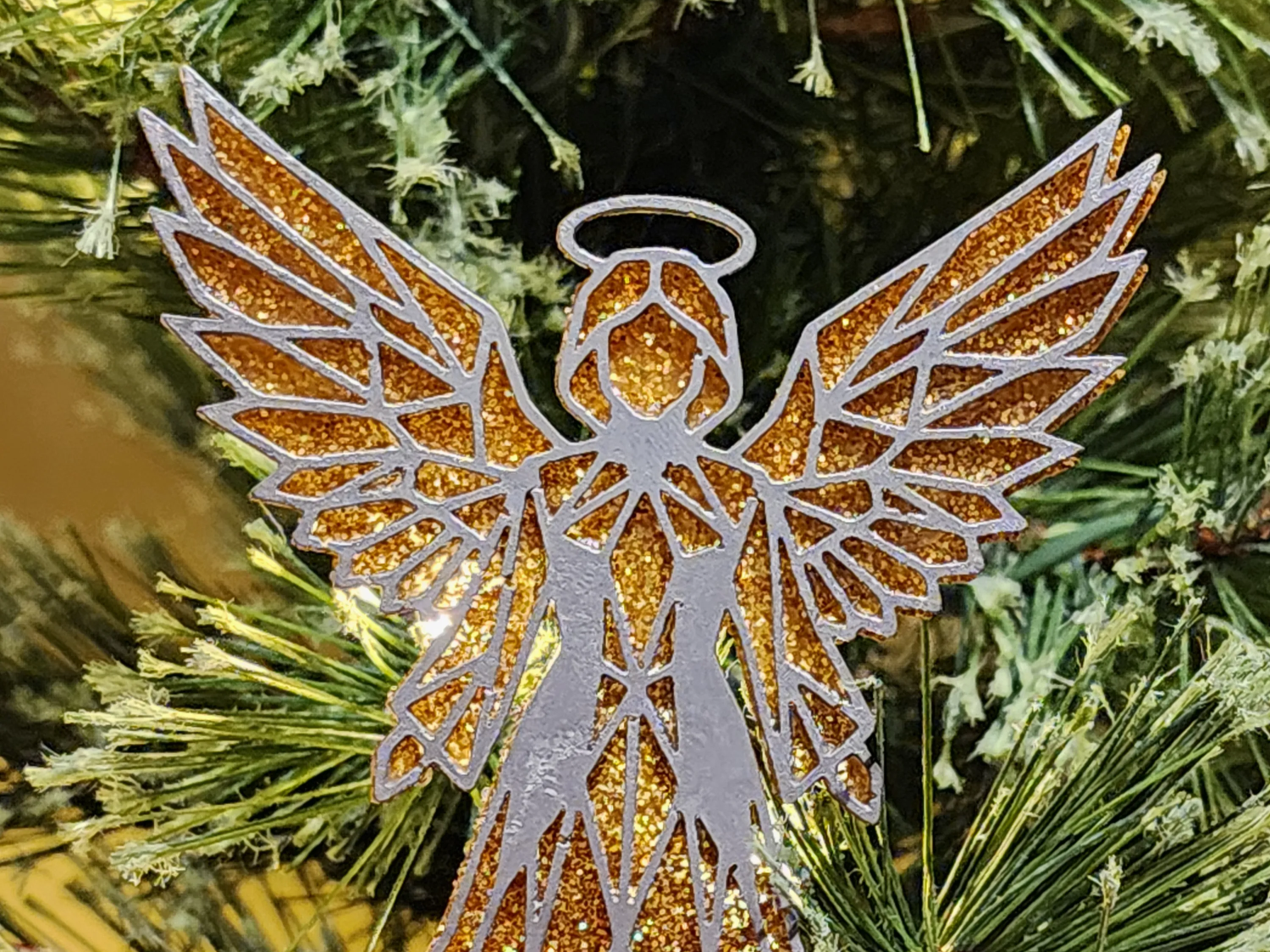 Glittery angel Christmas tree ornament with layered wings