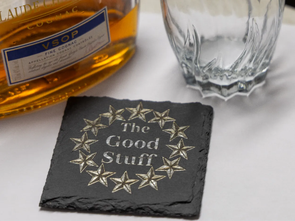 Square slate coaster with a silver laser foil star design