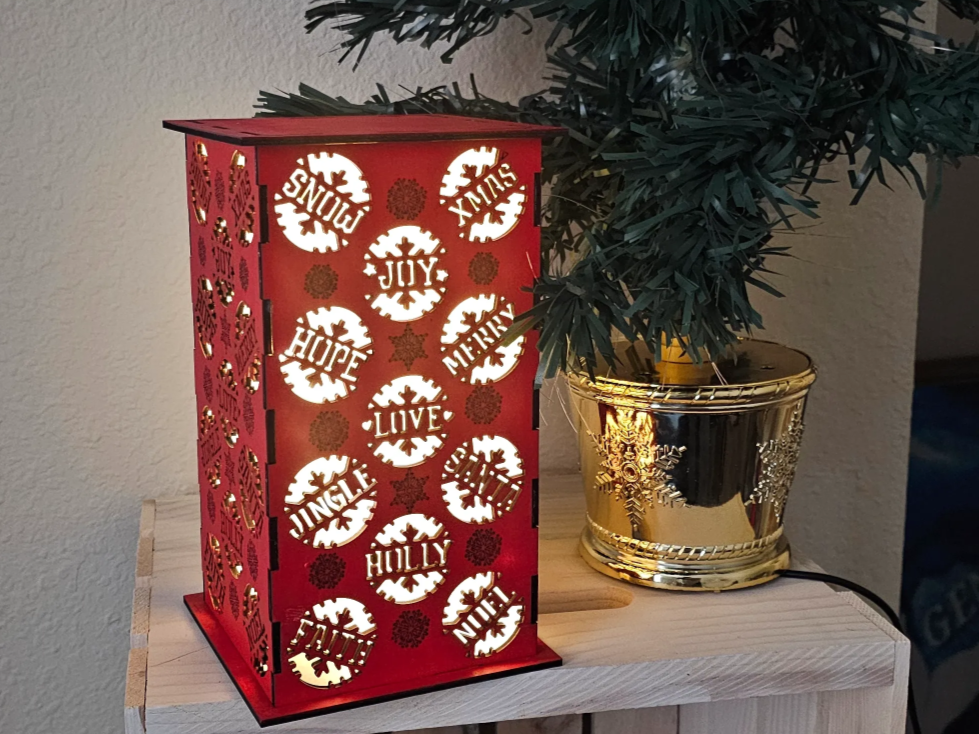 Decorative laser cut wooden Christmas lantern with ornate cutout panels