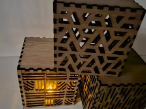Two lidded geometric laser cut wooden tealight lanterns glowing patio light idea