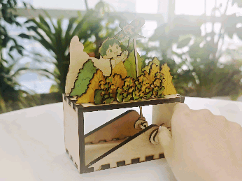 Mechanical Diorama Featuring a Boy Flying a Kite in a Field