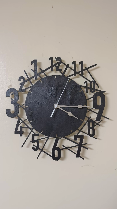 [Laser cut and engrave] Modern black geometric wall clock with abstract radial number arrangement