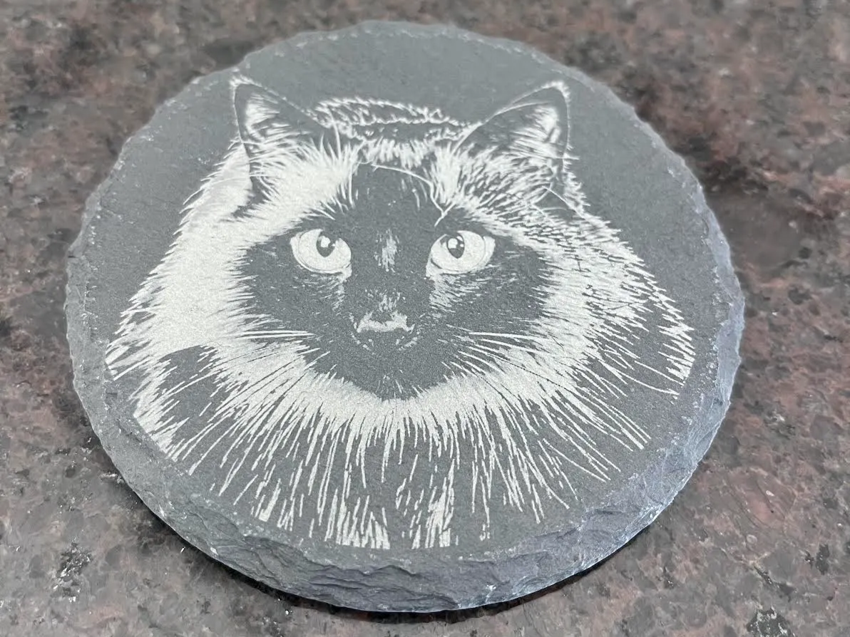 Round slate coaster engraved with a Siamese cat photo portrait