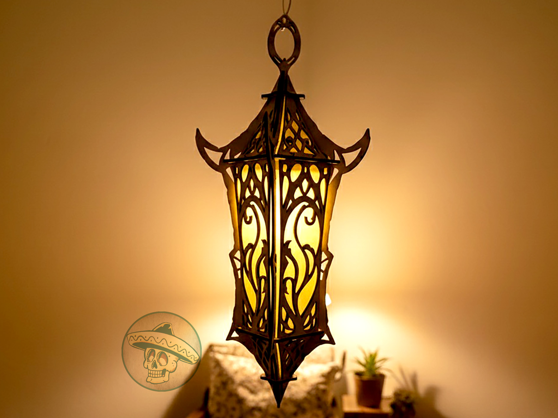 Tall ornate plywood lantern glowing warmly with hanging ring on top outdoor lantern idea