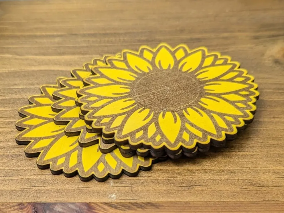 Laser cut wooden sunflower coasters finished with yellow paint