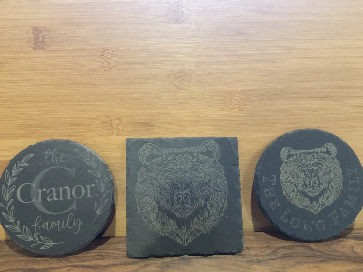 A natural stone coaster engraved with a monogram
