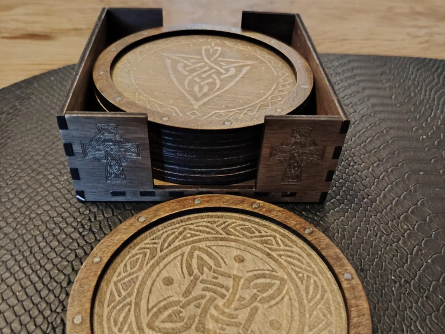 Wooden Celtic Knot Coaster Set with Holder laser cut design on a table