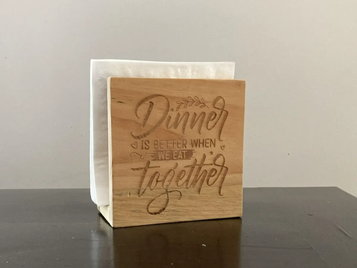 Dinner Quote Napkin Holder laser cut design on a table