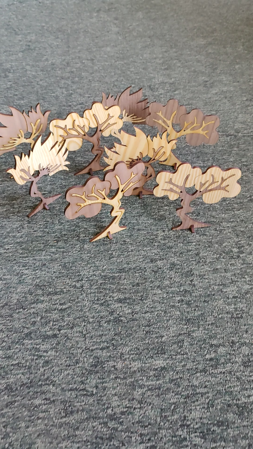 [Laser cut and engrave] Tree sprites or wood nymphs. Hand drawn two-tone trees with a hint of nymph