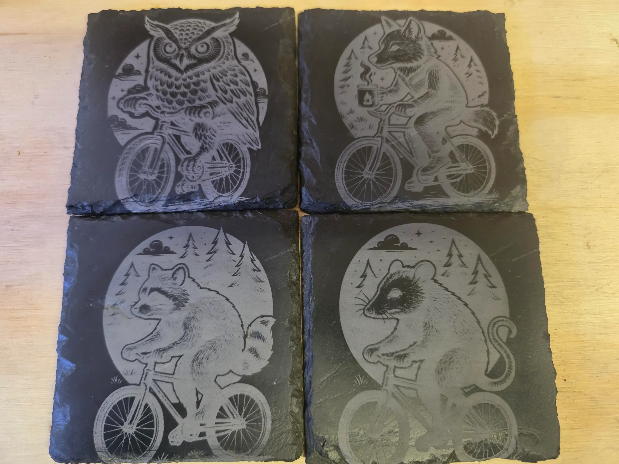 Slate coaster set featuring wildlife riding bikes