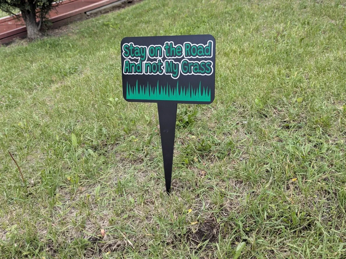 Simple laser cut wooden Christmas yard sign on a garden stake