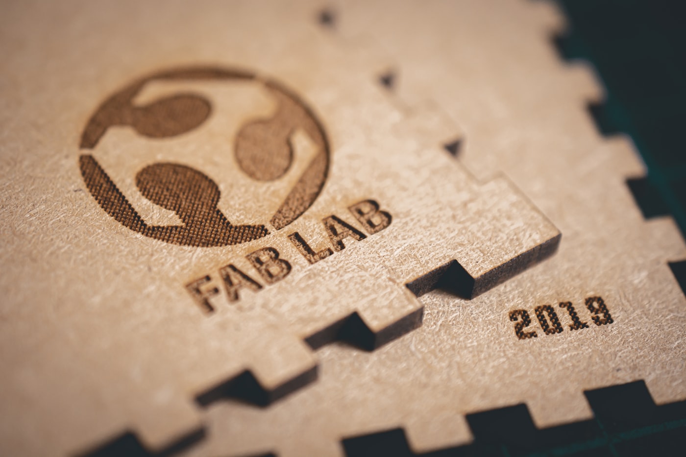 A laser engraving a design onto a hard flat material with a focused beam