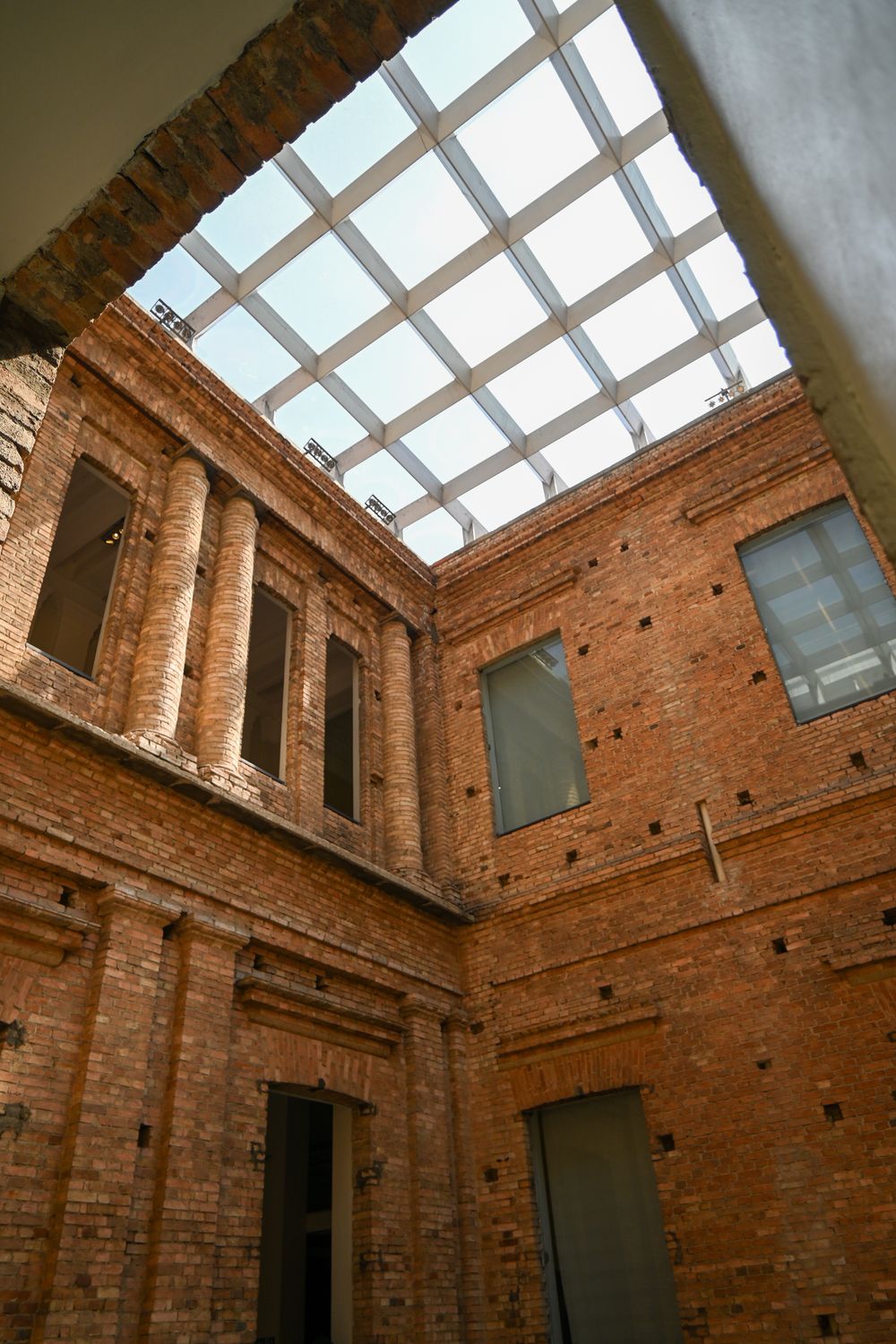 Exposed brick walls and a huge industrial skylight in a converted building