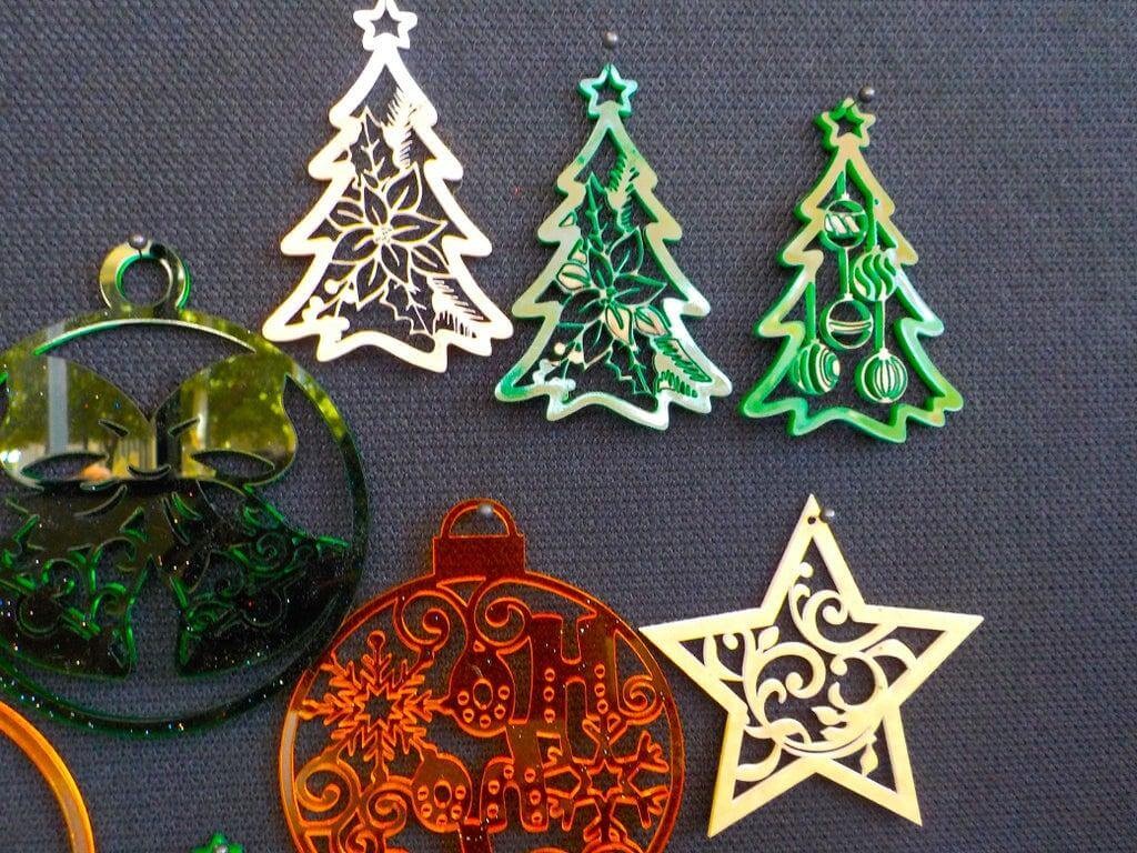 Colorful laser-cut acrylic Christmas ornaments in tree, star, and bauble shapes
