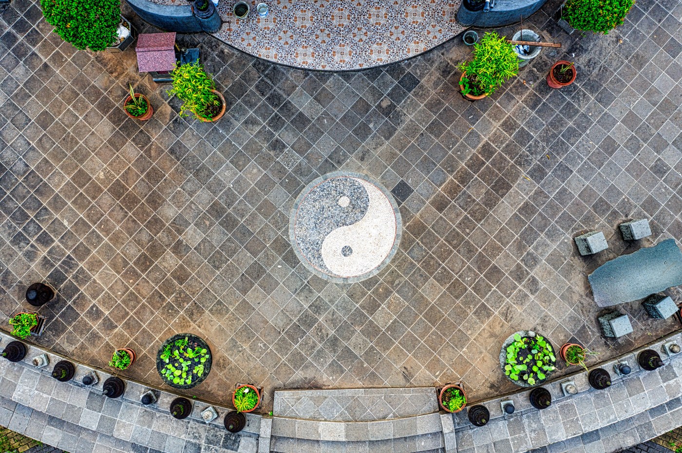 A yin yang symbol laid into a paved courtyard